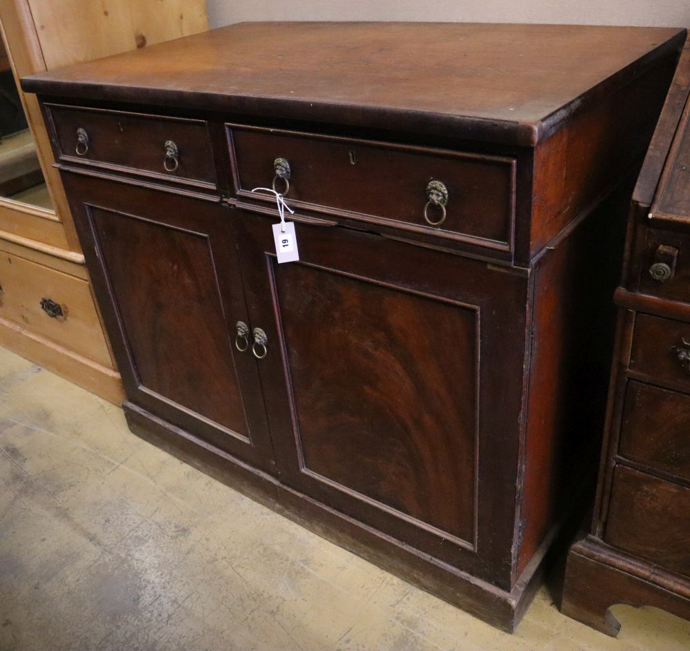 An early Victorian mahogany cabinet, fitted two drawers over panelled doors, width 114cm depth 67cm height 96cm